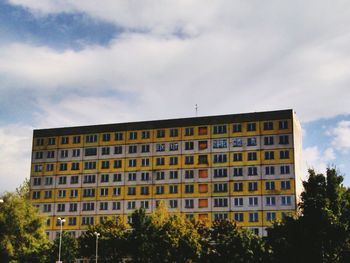Low angle view of building against cloudy sky