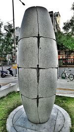 Close-up of footpath by street against sky