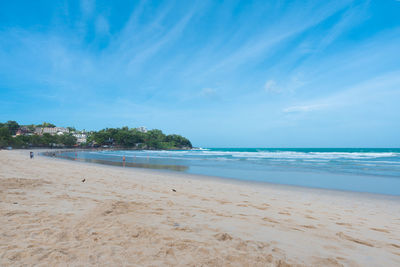 Scenic view of beach against blue sky