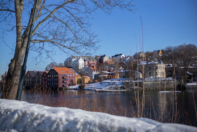 Houses against clear sky during winter