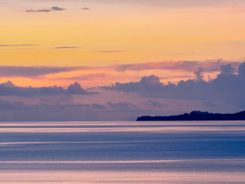 Scenic view of sea against romantic sky at sunset