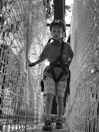 Portrait of boy amidst jungle gym at park