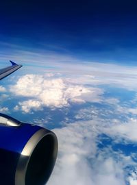 Cropped image of airplane flying over clouds
