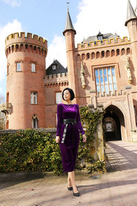 Woman standing in front of historical building