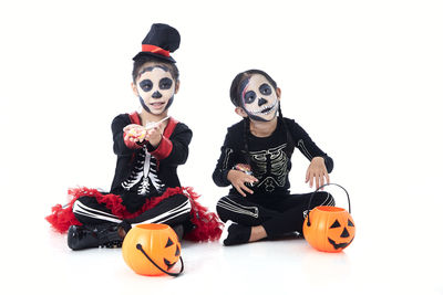 Full length of a boy with toys against white background