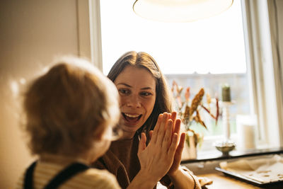 Mother clapping for baby son