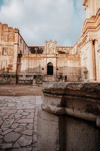 View of old building against cloudy sky