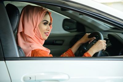 Portrait of woman sitting in car