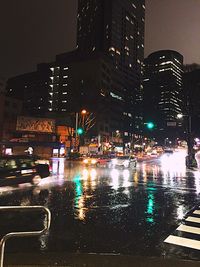 Illuminated cityscape against sky at night