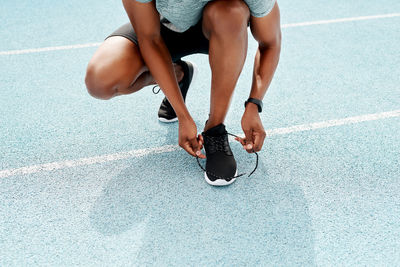 Low section of woman exercising on court