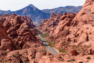 Rear view of man standing on rock formations