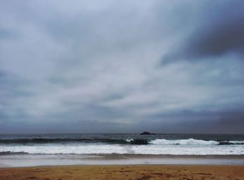 Scenic view of sea against cloudy sky