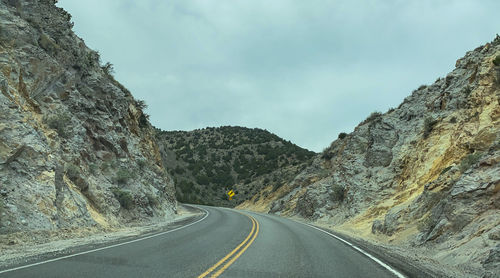 Road amidst mountains against sky