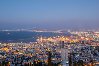 High angle view of illuminated city buildings against sky