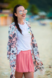 Mid adult woman wearing sunglasses standing outdoors