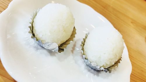 High angle view of rice balls in plate on table