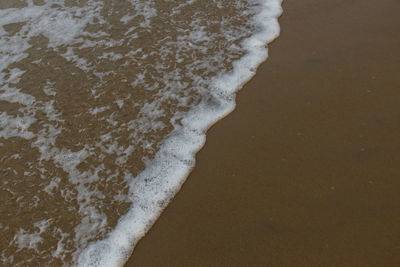 High angle view of surf on beach