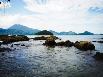 Scenic view of lake against cloudy sky