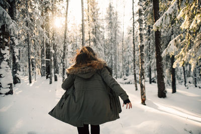 Rear view of woman on snow covered land