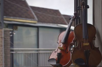 Close-up of violins by window