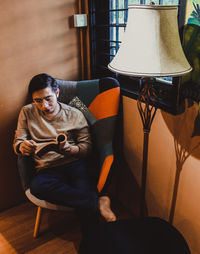 Man sitting on chair at home