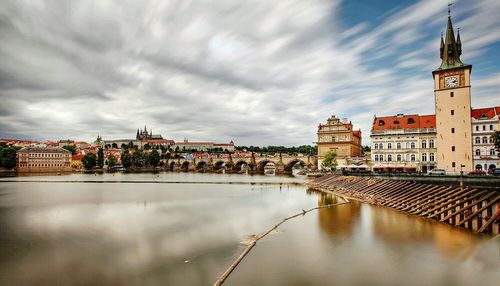 Buildings in city against cloudy sky