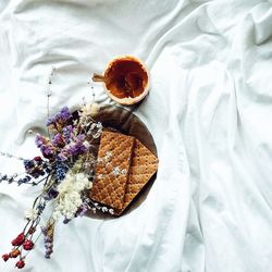 Directly above shot of food with flowers on bed