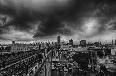 Buildings in city against cloudy sky