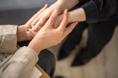 Cropped image of people stacking hands