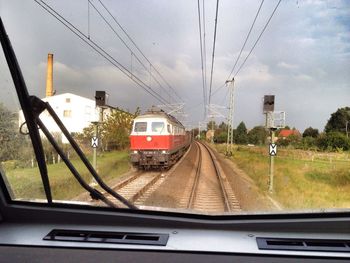 Railroad tracks seen through train windshield