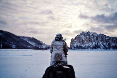 Rear view of snowcapped mountains against sky