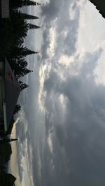 View of storm clouds over palm trees