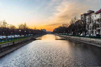 Scenic view of river against sky during sunset