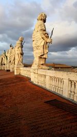 Low angle view of old building against cloudy sky