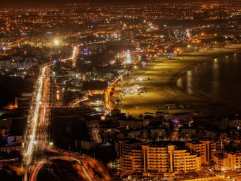 High angle view of illuminated city buildings at night