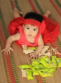 High angle portrait of cute baby girl sitting at home