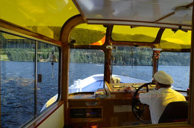 Man sitting on boat sailing in sea