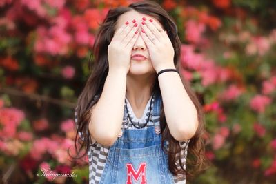 Portrait of beautiful young woman with red eyes closed