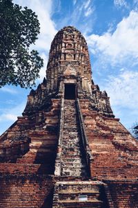 Low angle view of old temple against cloudy sky