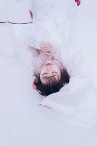 High angle view of woman sleeping on bed