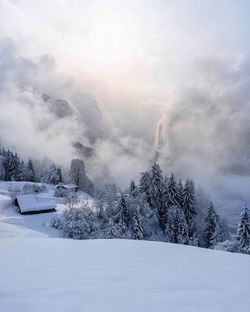 Scenic view of snow covered landscape against sky