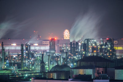 Illuminated cityscape against sky at night