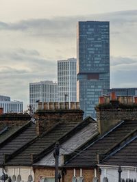 Buildings in city against sky