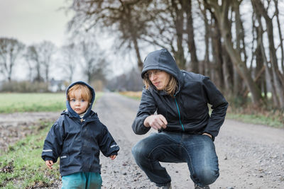 Full length of boys on road during winter