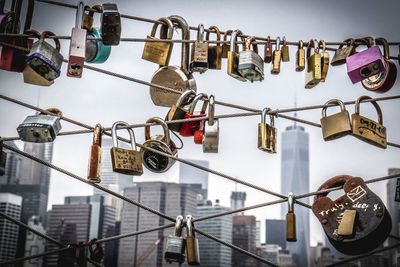 Padlocks attached in fence against one world trade center