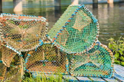 A close up picture of piled fishing trap net cages resting on the pier