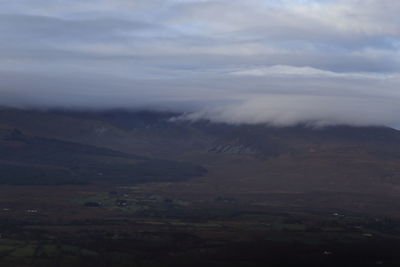 Scenic view of mountains against cloudy sky