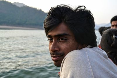 Portrait of young man looking away outdoors