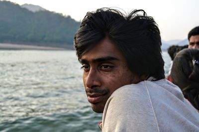 Side view of thoughtful man looking away by river