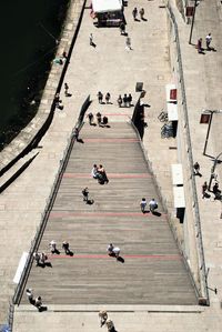 High angle view of people on staircase during sunny day